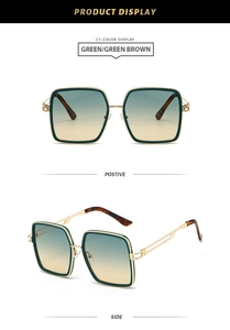 Detail view of square green sunglasses with gold accents and gradient lenses