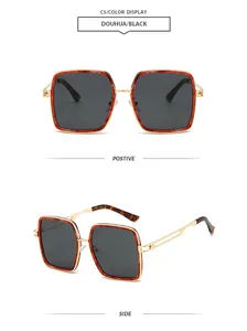 Detail view of square tortoiseshell metal frame sunglasses with dark grey lenses