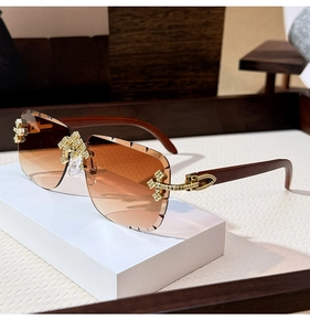 Detail of rimless gradient sunglasses with gold cross accent and real wood arms