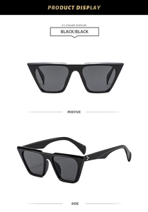 Detail of black retro thick frame sunglasses with silver petal studs and dark grey lenses