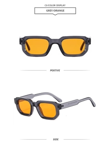 Detail view of square vintage sunglasses with grey transparent frames and orange lenses
