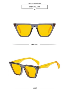 Detailed front and side view of oversized grey frames with vibrant orange-yellow lenses