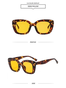 Detail of vintage thick cat eye sunglasses in tortoiseshell frame with yellow lenses