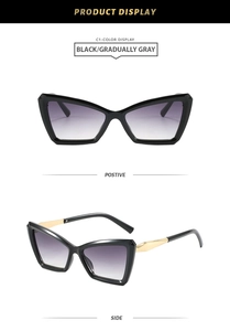 Detailed view of cat eye sunglasses with black frames, grey lenses, and gold metal temples