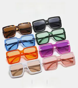 Flat lay of retro square oversized sunglasses in eight vibrant candy colors and gradients