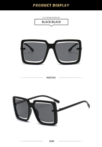 Detail view of oversized square sunglasses featuring unique double frame design in black