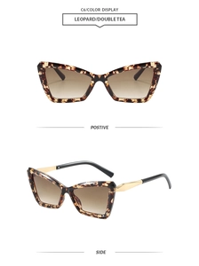 Detail of cat-eye leopard frame sunglasses with tea gradient lenses and gold metal temples