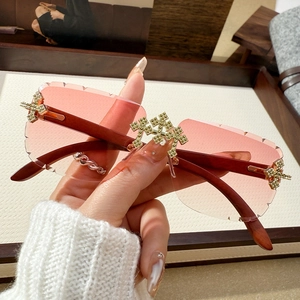Frameless square sunglasses with pink gradient lenses, wood temples and rhinestone crosses