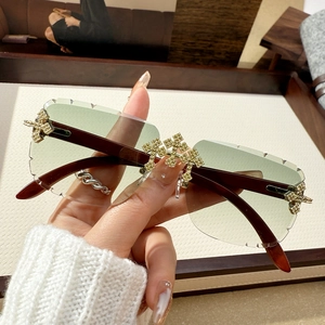 Fashionable rimless square sunglasses with green gradient lenses and rhinestone cross