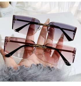 Detail of rimless square sunglasses with purple gradient lenses and gold metal bridge