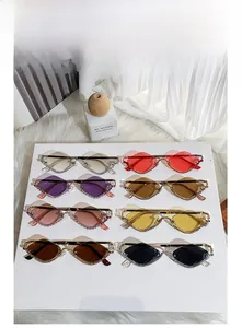 Close-up of assorted rhinestone-studded diamond-shaped sunglasses in eight vibrant colors