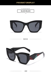 Détail de lunettes de soleil œil-de-chat noires avec branches à motifs rouge et vert