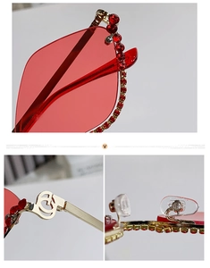 Detail of red rhinestone trim on rimless lenses and golden metal hinge craftsmanship