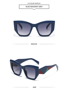 Gros plan de lunettes de soleil œil-de-chat bleu marine avec verres dégradés et branches colorées