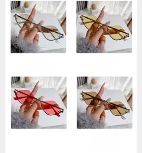 Detail view of four rimless rhinestone sunglasses in grey, yellow, pink and tea colors