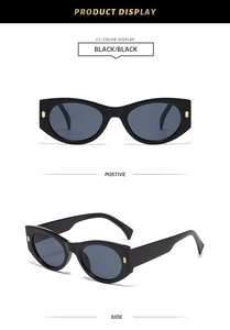 Detail view of black cat-eye sunglasses with golden metal accents on wide temples