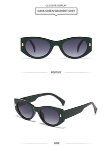 Detail view of dark green cat-eye sunglasses with gradient grey lenses and gold accents