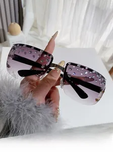 Detail of purple gradient frameless sunglasses with shimmering inlaid rhinestones