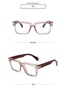 Detail view of tea-colored square chunky eyeglass frames with gold metal hinges