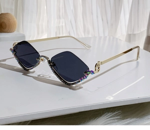 Detail of diamond-encrusted rimless sunglasses with unique musical note metal temples