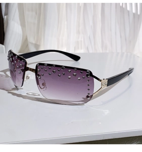 Detail of rimless purple gradient lenses with rhinestones and gold metal nose bridge