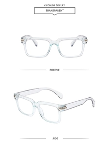 Detail of transparent square frame glasses with elegant gold metal temple accents