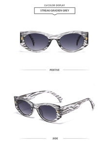 Detail of zebra pattern sunglasses with grey gradient lenses and gold hinge accents