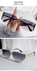 Detail view of rimless square sunglasses with grey pink gradient lenses and gold metal frame