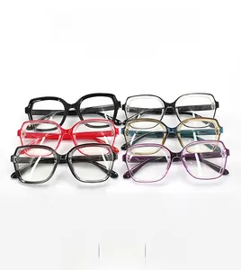 Flat lay of oversized retro eyeglass frames in six assorted colors on white background