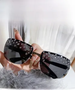 Close-up of grey rimless sunglasses with sparkling rhinestones on the lenses