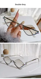 Detailed view of diamond-shaped sunglasses with gradient grey lenses and colorful rhinestones