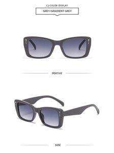 Detail view of grey square sunglasses with rhinestone accents and gradient lenses