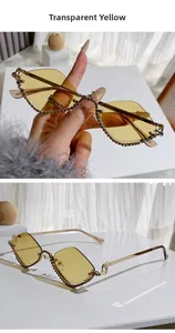Close-up of yellow lens sunglasses with rhinestone rim and gold metal frame temples