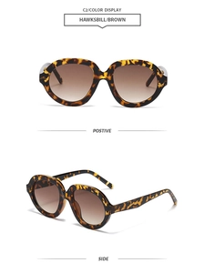 Detail view of tortoiseshell brown oversized sunglasses with brown gradient lenses
