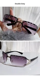 Detailed macro of rimless sunglasses featuring grey gradient lenses and crystal rhinestones