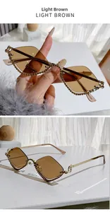 Detail of light brown rimless diamond sunglasses with gold metal temples and crystal trim