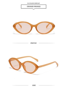 Detail view of orange retro cat-eye sunglasses with transparent frame and colored lenses