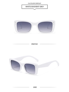 Detail view of white square sunglasses with rhinestone accents and gradient grey lenses