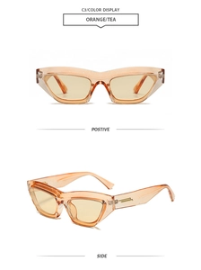 Detail view of orange cat eye sunglasses with transparent frames and tea-tinted lenses
