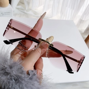 Fashionable rimless rectangular sunglasses with pink gradient lenses and gold bridge