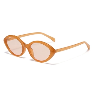 Retro oval cat-eye sunglasses with translucent amber frames and light pink tinted lenses