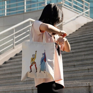 Detailed shot of white canvas tote bag featuring traditional Chinese monkey king art