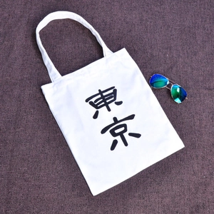 Detail der weißen Canvas-Einkaufstasche mit schwarzem Tokio-Aufdruck und Baumwolltextur