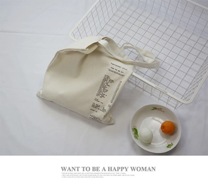 Detail of off-white canvas tote bag featuring a creative supermarket receipt print design