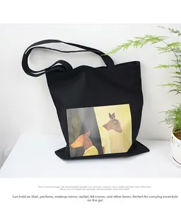 Detailed view of black canvas tote bag showing interior space for iPad and essentials