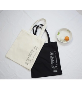 Detail of canvas tote bags with creative supermarket receipt print and durable fabric texture