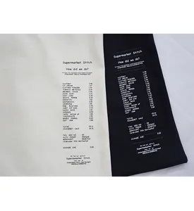 Detail of creative supermarket receipt print on minimalist canvas shoulder bag surface