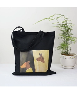 Detail of artistic deer illustration on a black canvas tote bag with a minimalist plant background