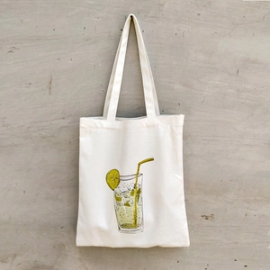 Detail of white canvas tote bag featuring a refreshing lemon cold drink illustration