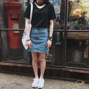 Outdoor street style showcasing a minimalist white canvas tote bag with a casual summer outfit